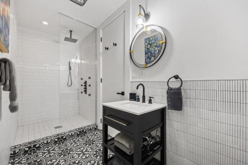 a white bathroom with a sink and a shower at The Perfect Apt for Large Groups Sleeps 10 in New York