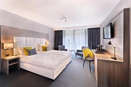 Postel nebo postele na pokoji v ubytování Van der Valk Hotel Nazareth-Gent