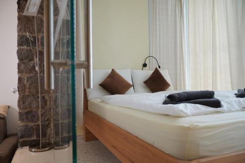 a bed with white sheets and pillows in a room at Gardar in Bolzano