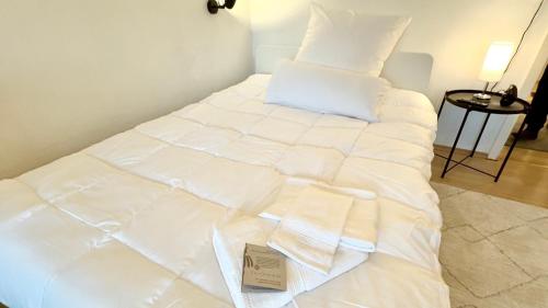 a large white bed with a sign on it at City Appartement in Ulm Old City-Center in Ulm