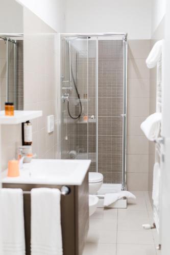 a white bathroom with a shower and a toilet at Dieci by Comorooms in Como