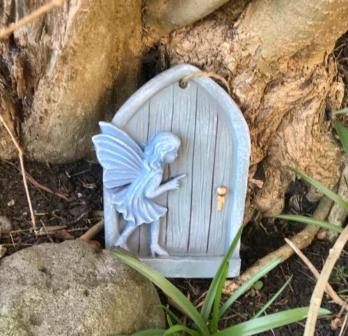 a small blue angel sitting on a door at fAiRy DeLL Guesthouse, with cozy lockable rooms, tv, tea tray with choccies, free wifi and parking, 24hr check in, COA, all are welcome in Bradford