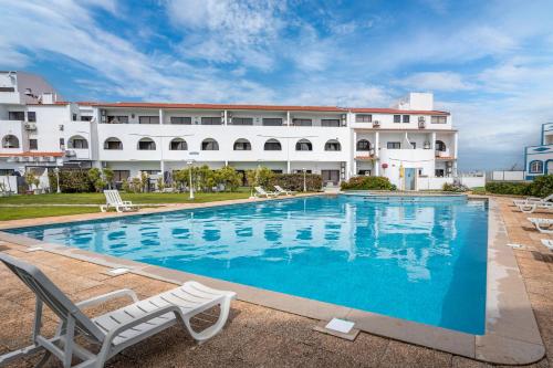 a large swimming pool in front of a building at Cozy Apartment In Sagres in Sagres