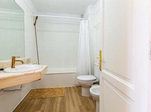 a white bathroom with a sink and a toilet at Sunset Flower Apt By Dream Homes Tenerife in Puerto de Santiago