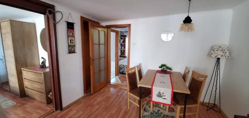 a dining room with a table and some chairs at Cozy Heritage Home in Prishtinas Historic Zone in Pristina