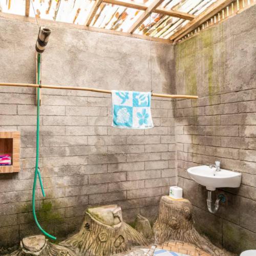 a bathroom with a sink and a shower and a sink at Pondok Inggris Homestay in Seganteng