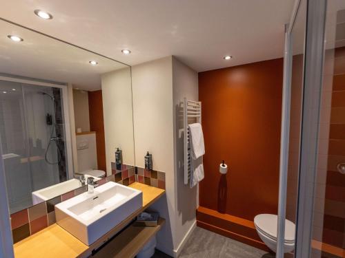 a bathroom with a sink and a toilet at Hotel Donibane Saint-Jean-de-Luz in Saint-Jean-de-Luz