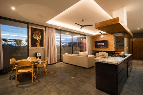 a kitchen and living room with a table and a couch at Villa Zilla by BaliSuperHost in Tegalalang