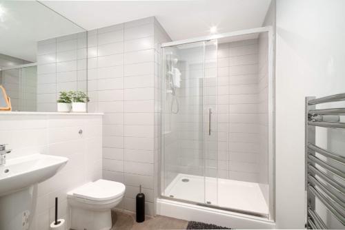a bathroom with a shower and a toilet and a sink at Modern Studio Apartment in Waterloo Liverpool in Liverpool