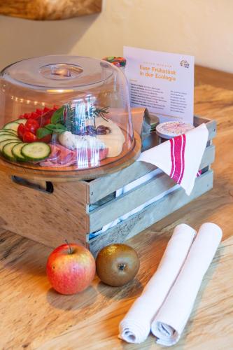 a display of fruit and vegetables on a table at Ecologie Grundlsee in Grundlsee