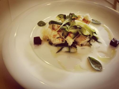 a white plate of food with vegetables on it at Locanda San Giorgio in Termoli