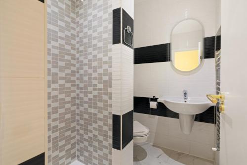a bathroom with a sink and a toilet at London Star Hotel in London