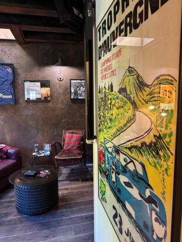 a room with a wall with a poster of a mountain at Classic Driver Home 1 in Royat