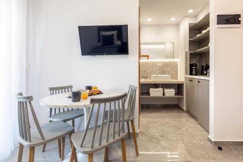 a kitchen and dining room with a table and chairs at Anna Studio in Amoudara Herakliou