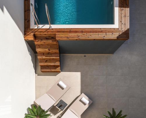 a bathroom with chairs and a swimming pool at Dea Del Porto Signature Suites in Rethymno