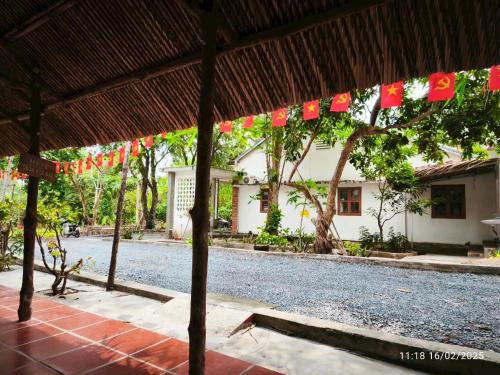 a house with a string of flags hanging from it at Nguyên căn Homestay Mẹ Khang 2 in Cu Chi