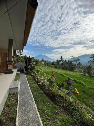 a house with a view of a green field at Sarwhe Nadi Homestay in Sidemen