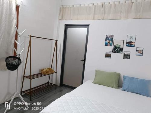 a bedroom with a bed and a mirror and a door at Nguyên căn Homestay Mẹ Khang 2 in Cu Chi