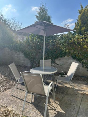 a table and chairs with an umbrella on a patio at The Perfect Place in Ennis