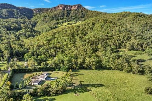 an aerial view of the property with mountains in the background at Serendipity, Kangaroo Valley in Barrengarry