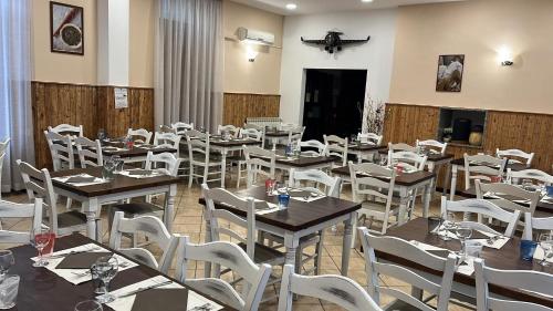 a dining room with tables and white chairs at Il Capriolo in Tavernelle