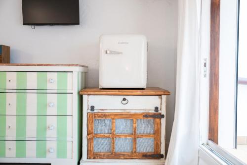 a white appliance sitting on top of a dresser at Casa La Roca in Pollença