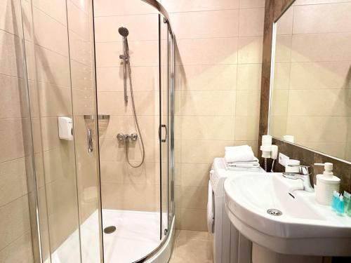 a bathroom with a shower and a sink at Kievinn in Kyiv