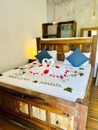 a bedroom with a large bed with a stuffed animal on it at Lala salama Kendwa villas in Kendwa