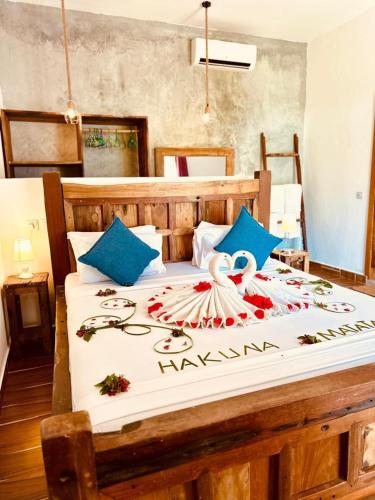a bedroom with a large bed with a swan on it at Lala salama Kendwa villas in Kendwa