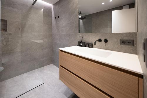 a bathroom with a sink and a shower at Lake 27 - St Moritz in St. Moritz