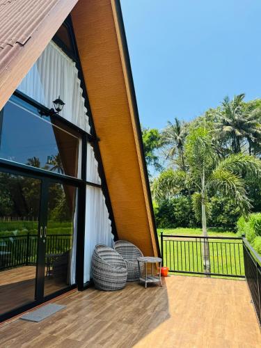 an enclosed patio with a view of a palm tree at Lombok Hidden Villa in Tetebatu
