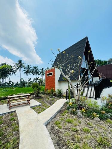 a building with a bench next to a park at Lombok Hidden Villa in Tetebatu