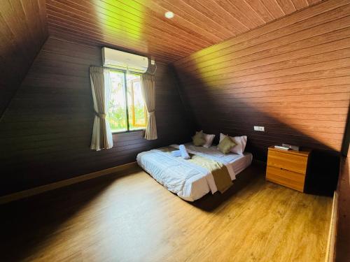 a bedroom with a bed and a window at Lombok Hidden Villa in Tetebatu