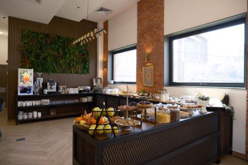 a buffet line in a restaurant with food on it at Hotel Monday by DNT Group in Tbilisi City