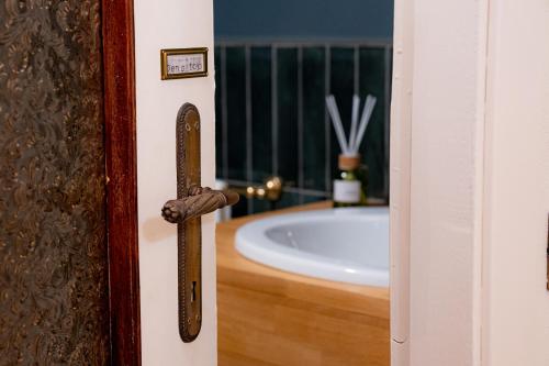a bathroom door with a tub in the background at Villa Bruno Selvago in Lessona in Lessona