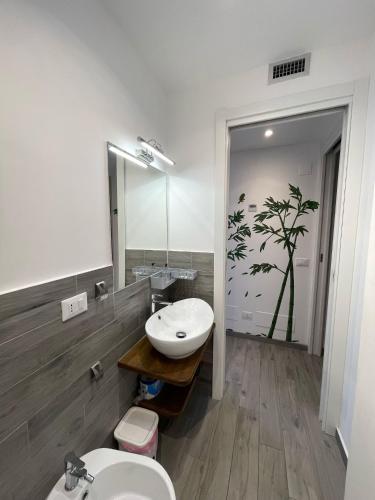 a bathroom with a sink and a toilet and a mirror at Casa Macallè - Letojanni - Taormina in Letojanni