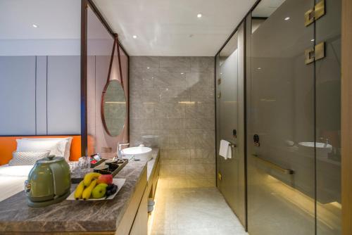 a bathroom with a sink and a toilet and a shower at Elegant International Hotel Shanghai - Bund Sichuan Road North Metro Station Branch in Shanghai