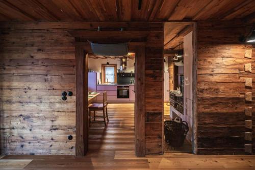 an open door into a kitchen with wooden walls at Schmiedgut Bad Aussee in Bad Aussee
