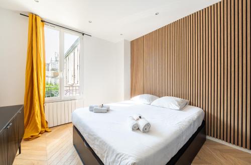 a bedroom with a bed with two stuffed animals on it at Mobility lease l Neuilly l Equipped & Paris 10mins away in Neuilly-sur-Seine