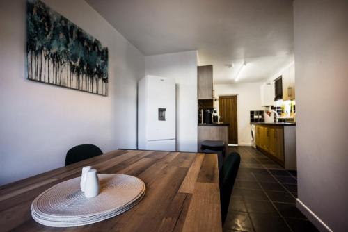 a dining room table with a plate on top of it at Spacious 4 Bed with Free Parking in Southampton