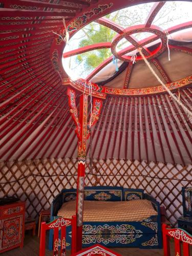a room with a bed in a yurt at Le Village Insolite yourte et roulotte in Saint-Benoît-des-Ondes