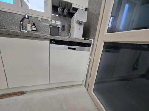 a kitchen with a sink and a counter top at Ulsan Shimpo KCC Residence in Ulsan