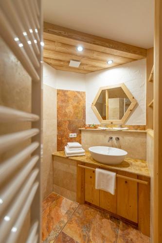 a bathroom with a sink and a mirror at Ecologie Grundlsee in Grundlsee