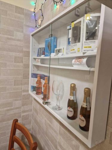 a wine cellar with bottles and a wine glass at Althea Etna Garden in Nicolosi