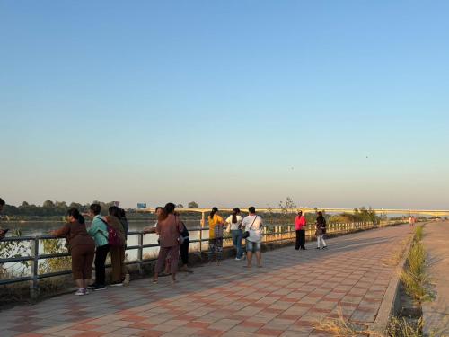 a group of people standing on a bridge at Royal Mekong Riverside Hotel in Nong Khai