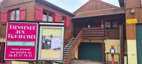 a building with a sign in front of it at Gîte et chambres d'hôtes Les Framboises in Katzenthal