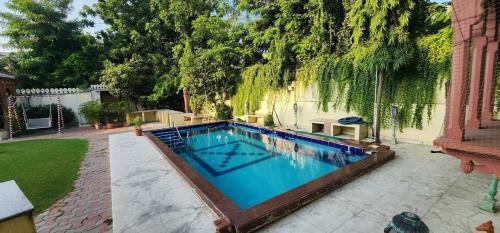 a swimming pool in the backyard of a house at PLAY IKSHANA Hotel in Jaipur