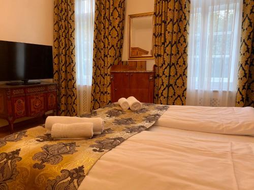 a hotel room with a bed with towels on it at Kurhaus Bad Doberan in Bad Doberan