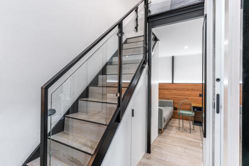 a staircase with glass railings in a house at CC Atocha Apartments in Madrid