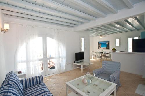 a living room with a couch and a table at Sofia's Bungalows Mykonos in Mýkonos City